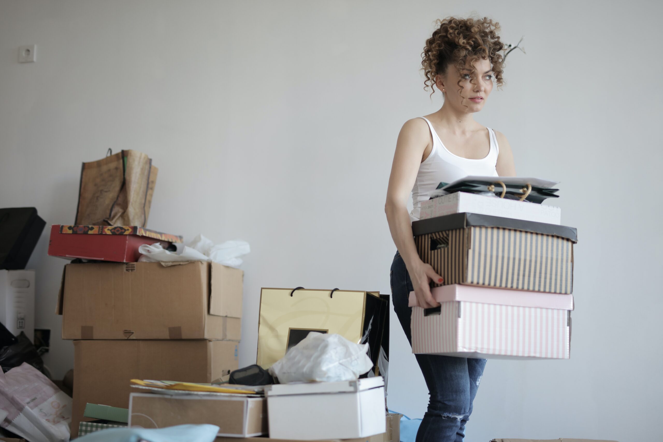 Women moving removals packing boxes